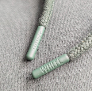 White London Clothing earth green 100% cotton hoodie drawstring tips with embossed logo detail.