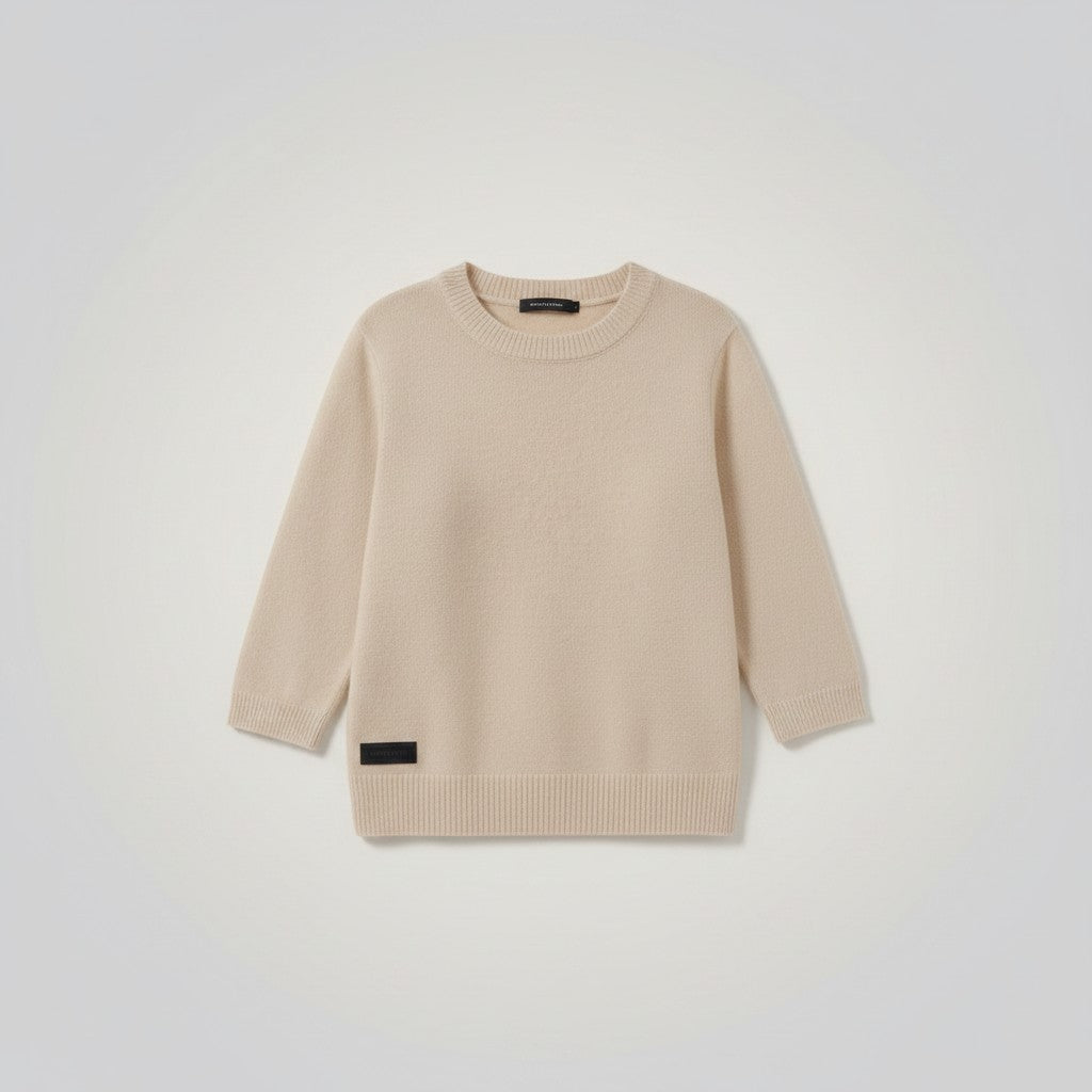 White London Clothing taupe knitted sweater with crew neck and ribbed hem. Features a small black logo patch on the lower left side.